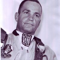 Headshot of gentlemen with short hair wearing skydiving gear.