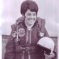 Paddy Miller smiling while wearing skydiving gear.