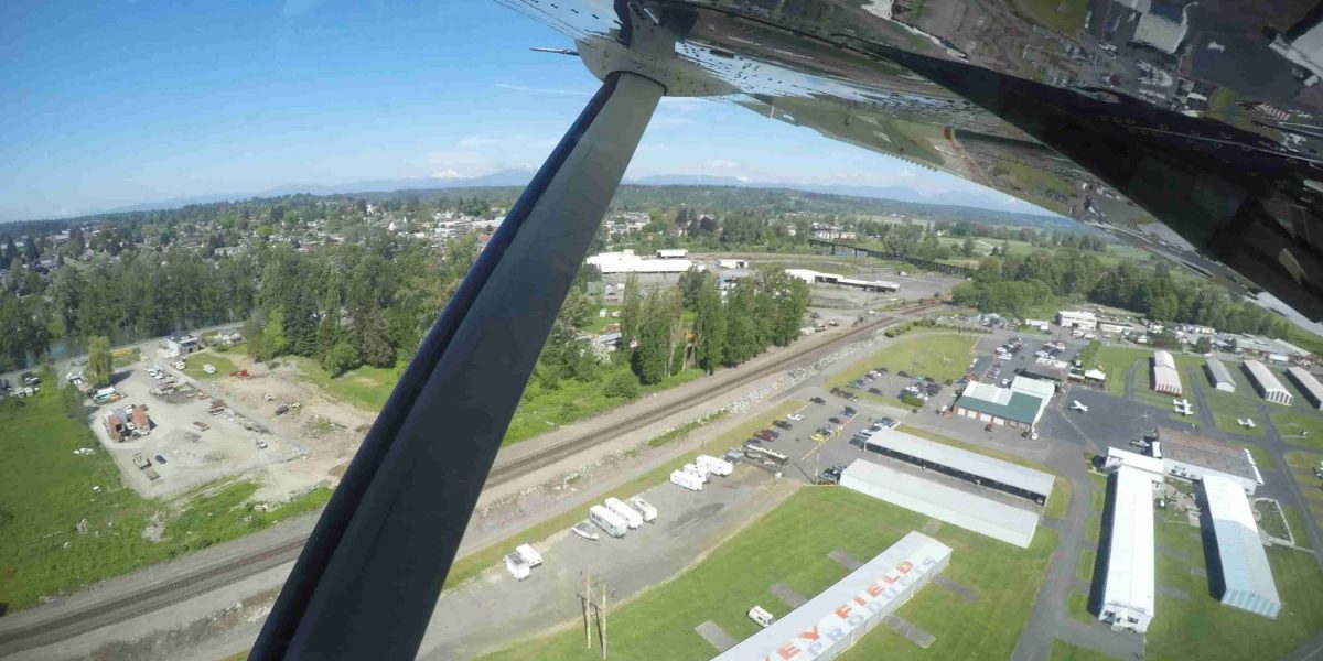 Area shot of the skydive snohomish airport surrounded by green grass.