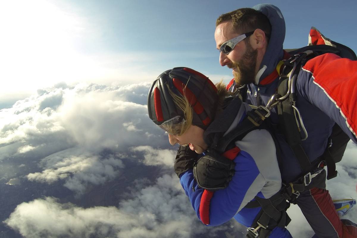 woman looks down in skydiving freefall
