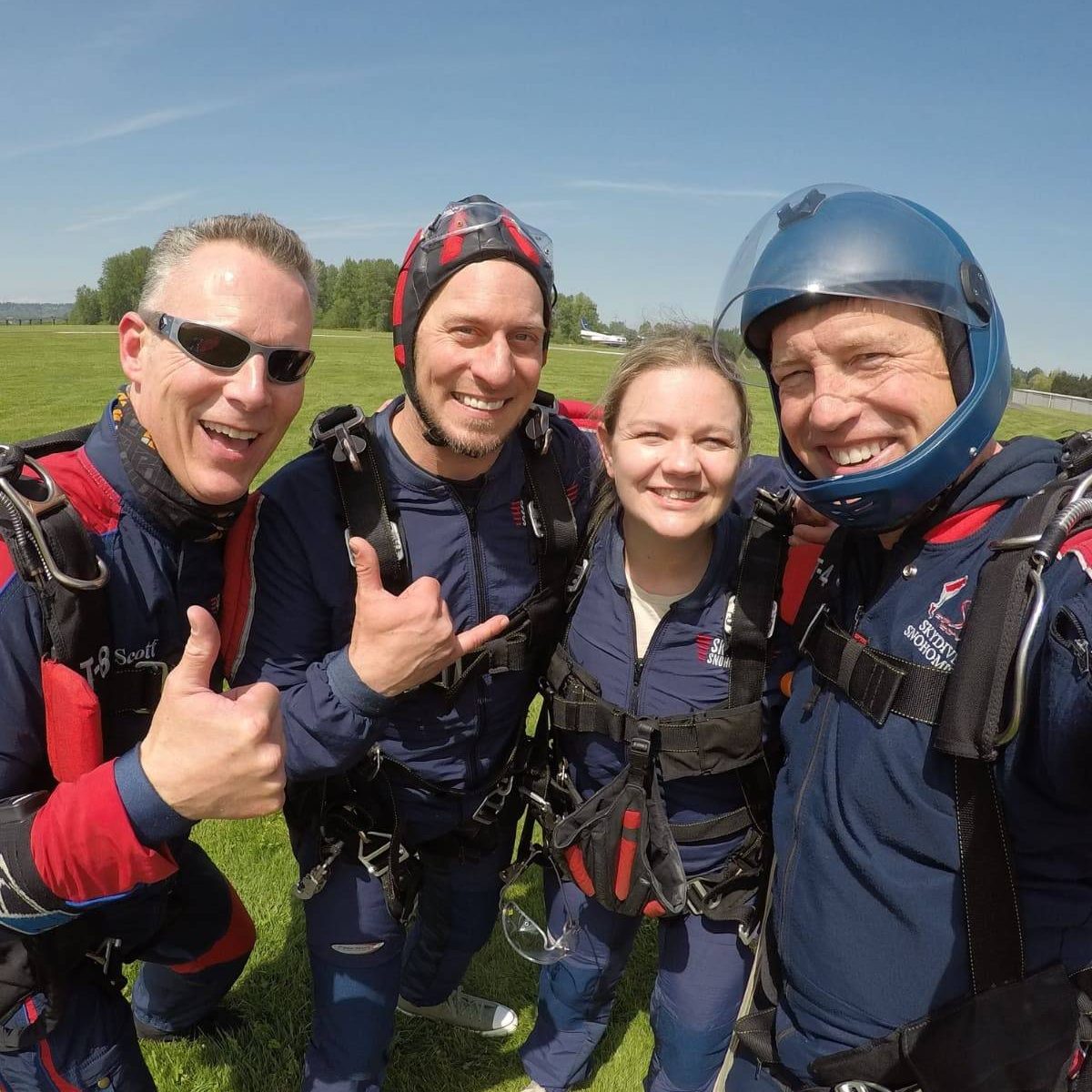 Tandem instructors smiling at Skydive Snohomish landing area.