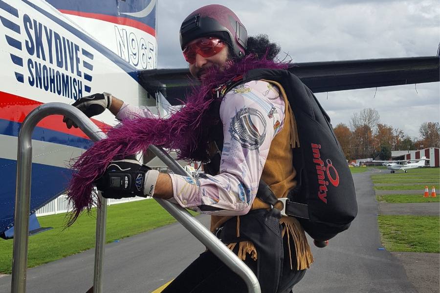 licensed skydiver boards plane weather helmet and purple boa