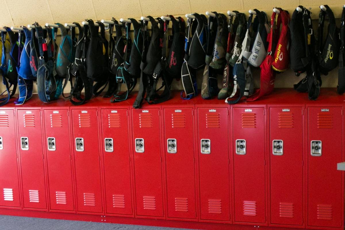 rigs hang neatly over red lockers