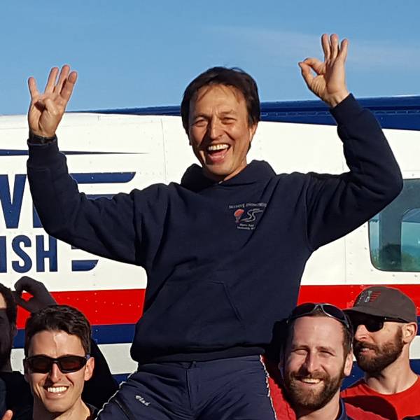 Vladimir Ursachii on the teams shoulders in front of the Red, White, and Blue Skydive Snohomish plane