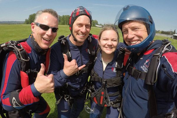 Tandem instructors smiling at Skydive Snohomish landing area.